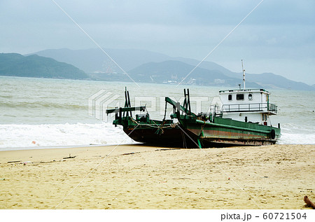 Fishing ship aground on the beach after a storm, Vietnam. 60721504
