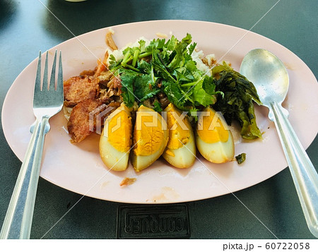 Asian gourmet Stewed pork leg on rice topped with egg and pickled vegetable  60722058