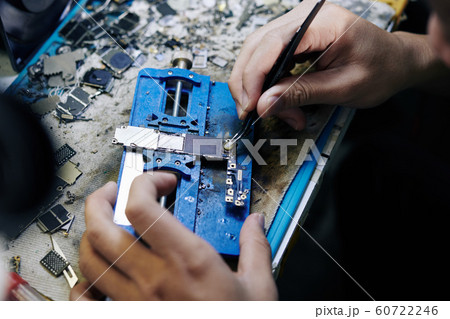 Repairman applying solder paste 60722246