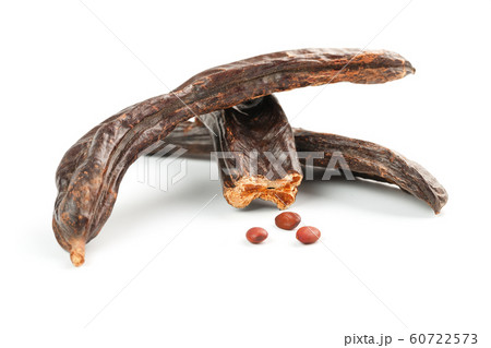 Carob carob fruit and seeds on white background. 60722573