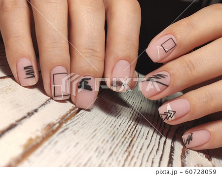 Gray striped nail design on female hand close up. 60728059