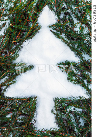 figure of a Christmas tree laid out of spruce twigs 60729818