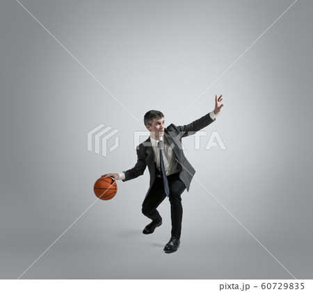 Caucasian man in office clothes training isolated on grey studio background 60729835