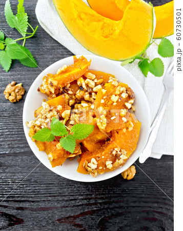 Pumpkin with nuts and honey on wooden board top Pumpkin with nuts and honey on wooden board top 60730501