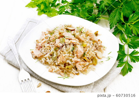 Salad of salmon and rice in plate on wooden board 60730516