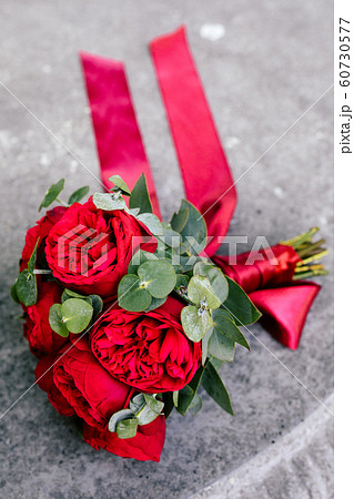 Wedding bouquet with red roses on the table 60730577