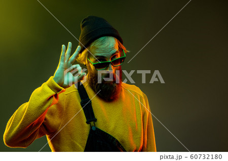 Caucasian man's portrait isolated on gradient studio background in neon light Caucasian man's portrait isolated on gradient studio background in neon light 60732180