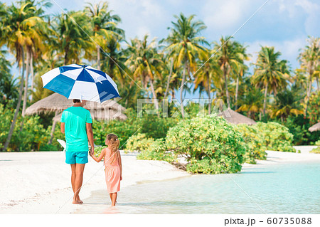 Little girl and happy dad having fun during beach vacation 60735088
