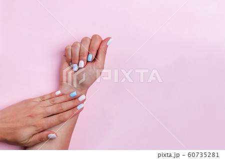 Woman's hands on pink table showing beautiful salon manicure 60735281