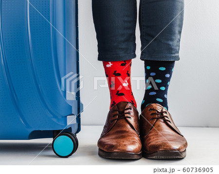 Stylish suitcase, men's legs and bright socks Stylish suitcase, men's legs and bright socks 60736905