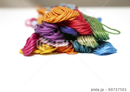 Colored threads for embroidery, seven colors of the rainbow lie in a row on a white background Colored threads for embroidery, seven colors of the rainbow lie in a row on a white background 60737501