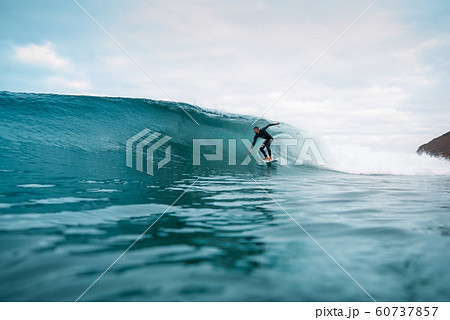 surfer riding waves on the island of fuerteventura 60737857