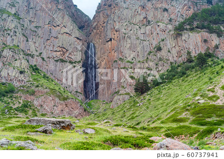 Summer landscape with mountain waterfall between two rocks Summer landscape with mountain waterfall between two rocks 60737941