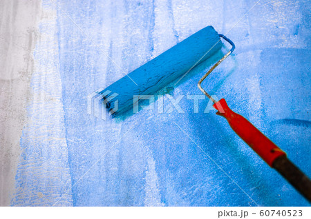 Long handle roller brush applying primer paint on 60740523