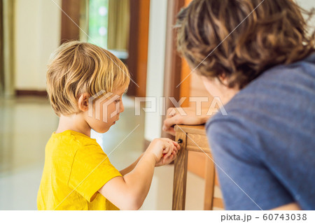 Father and son assembling furniture. Boy helping his dad at home. Happy Family concept 60743038