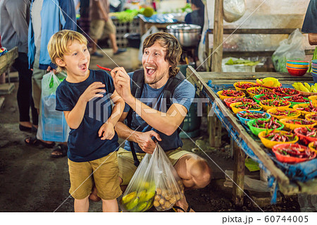 Dad and son are tourists on Walking street Asian food market 60744005