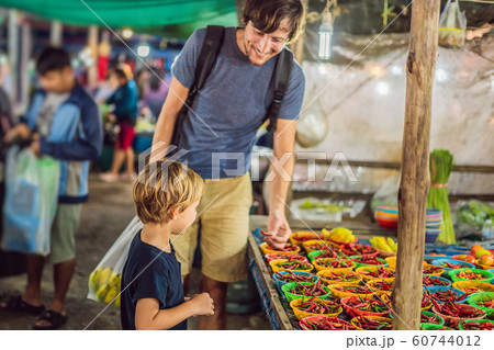 Dad and son are tourists on Walking street Asian food market Dad and son are tourists on Walking street Asian food market 60744012