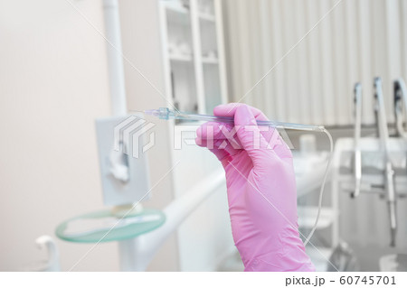 modern computer device in the hands of a dentist for anesthesia in dentistry 60745701