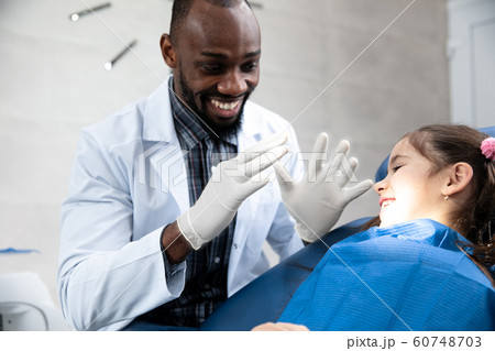 Young caucasian girl visiting dentist's office Young caucasian girl visiting dentist's office 60748703