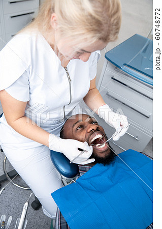 Young african-american man visiting dentist's office 60748772