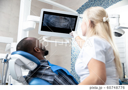 Young african-american man visiting dentist's office 60748776