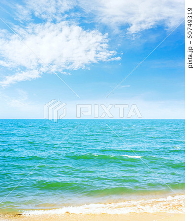 blue sky with clouds over sea and yellow sand 60749319