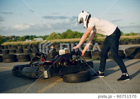 Handsome man in a karting with a car Handsome man in a karting with a car 60751570
