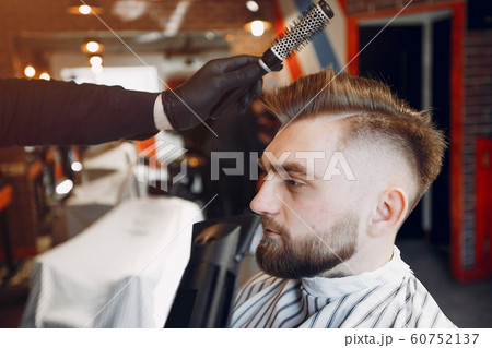 Stylish man sitting in a barbershop Stylish man sitting in a barbershop 60752137