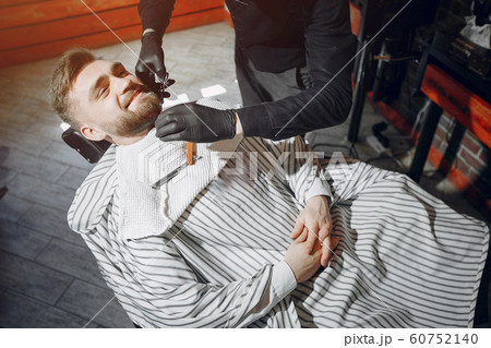 Stylish man sitting in a barbershop Stylish man sitting in a barbershop 60752140
