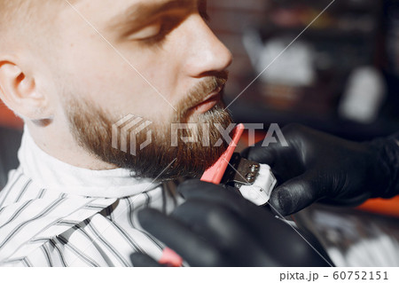 Stylish man sitting in a barbershop 60752151