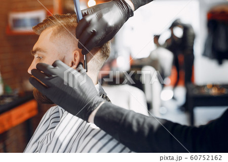 Stylish man sitting in a barbershop 60752162