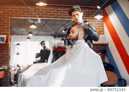 Stylish man sitting in a barbershop 60752181