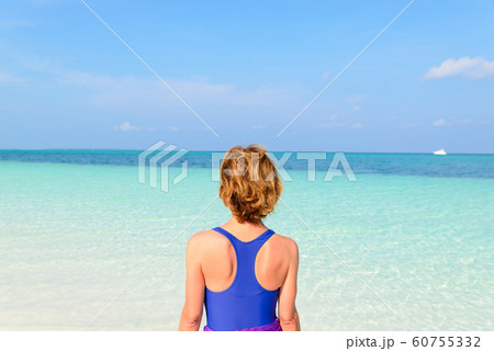 Woman sunbathing on turquoise transparent water, Woman sunbathing on turquoise transparent water, 60755332