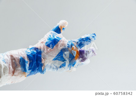 Big plastic hand made of garbage isolated on white studio background 60758342