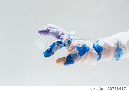 Big plastic hand made of garbage isolated on white studio background 60758417