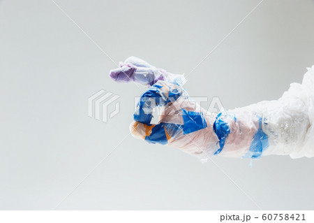 Big plastic hand made of garbage isolated on white studio background 60758421