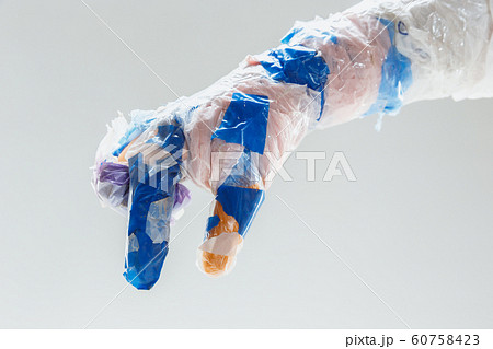 Big plastic hand made of garbage isolated on white studio background 60758423