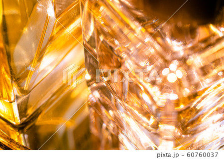 Beautiful bokeh and light reflections in yellow glass perfume bottles 60760037
