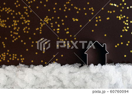 Miniature house on snow and a dark background with Miniature house on snow and a dark background with 60760094