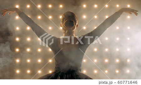 Silhouette of ballerina in black tutu is dancing ballet in the dark studio. Silhouette of ballerina in black tutu is dancing ballet in the dark studio. 60771646