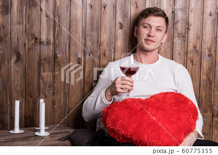 Young handsome man with a glass of wine and red 60775355