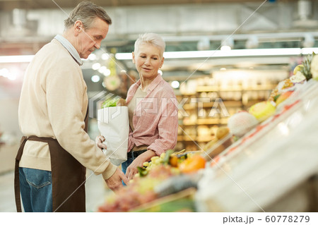 Mature Woman Buying Groceries at Market Mature Woman Buying Groceries at Market 60778279