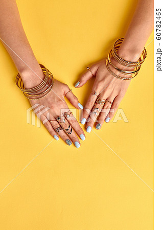 Beautiful summer gold bijouterie on female hands. 60782465