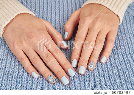 Close-up of female manicure on knitted background. Close-up of female manicure on knitted background. 60782497