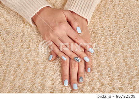 Delicate female hands on the fluffy knit Delicate female hands on the fluffy knit 60782509