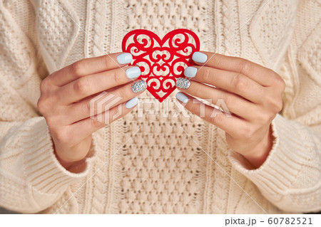 Beautiful openwork heart in female hands. Beautiful openwork heart in female hands. 60782521