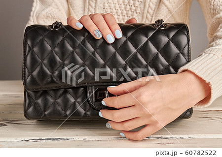 Girl with a nice manicure open handbag. Girl with a nice manicure open handbag. 60782522
