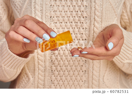 Jar with pills in female hands. Jar with pills in female hands. 60782531