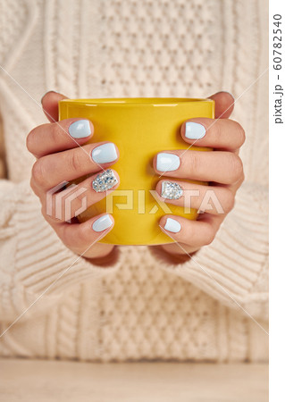 Woman holds a winter cup close up. Woman holds a winter cup close up. 60782540