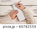 Beautiful female hand with manicure hold a pen. 60782559